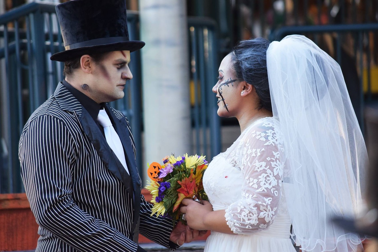 Ethan and Chantra Briggs exchange their vows while dressed as the bride and groom of Frankenstein during Six Flags Over Texas' HalloWedding celebration.