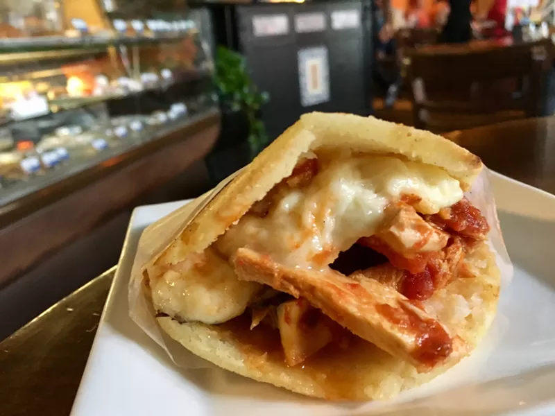 Image: A chicken and cheese arepa — a savory corn turnover — is $7.95.