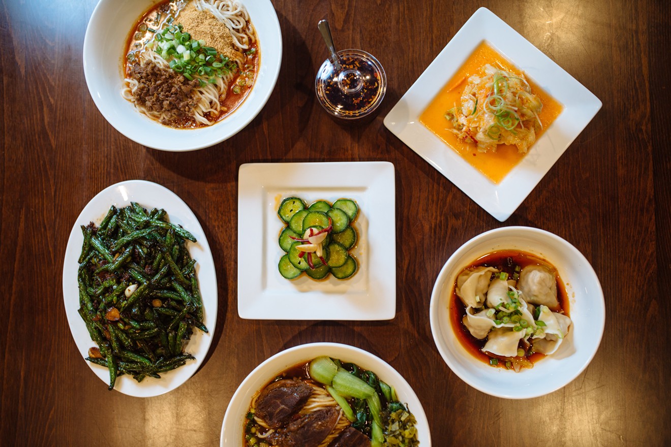Wu Wei Din's golden kimchi (top right) surrounded by cucumber salad, spicy wontons, two different noodle bowls and green beans.