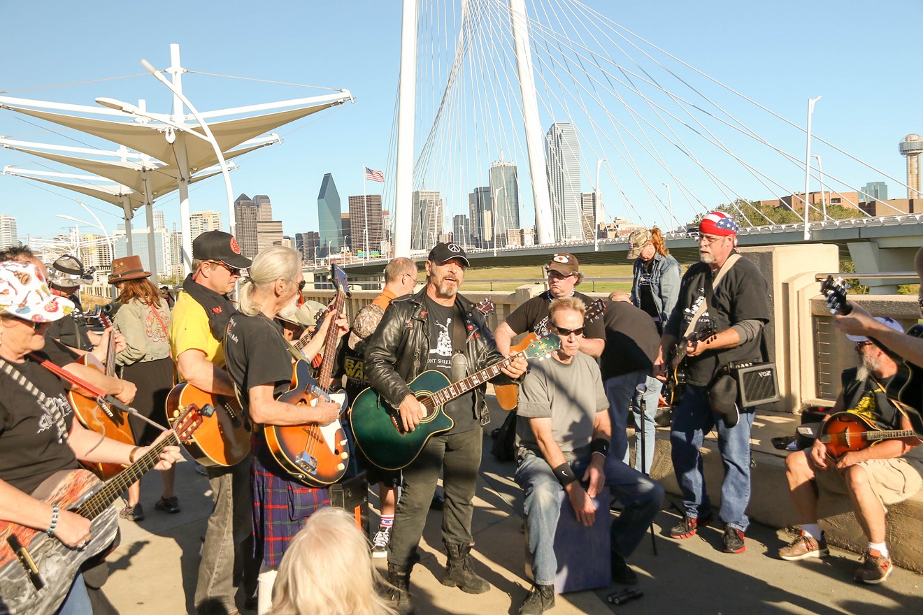 Barry "Kooda" leads a jam session on the Continental Avenue pedestrian bridge during the fourth annual Open Carry Guitar Rally.