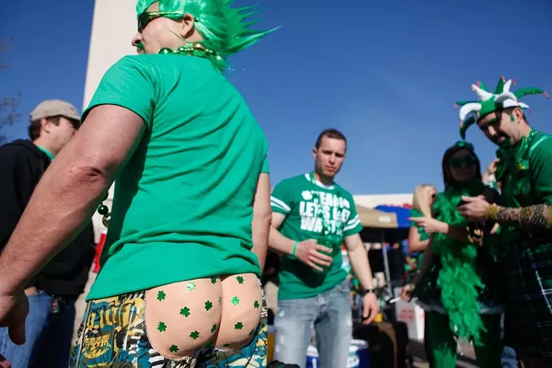 Image: A man shows his behind at a St. Patrick's Day parade in Dallas.