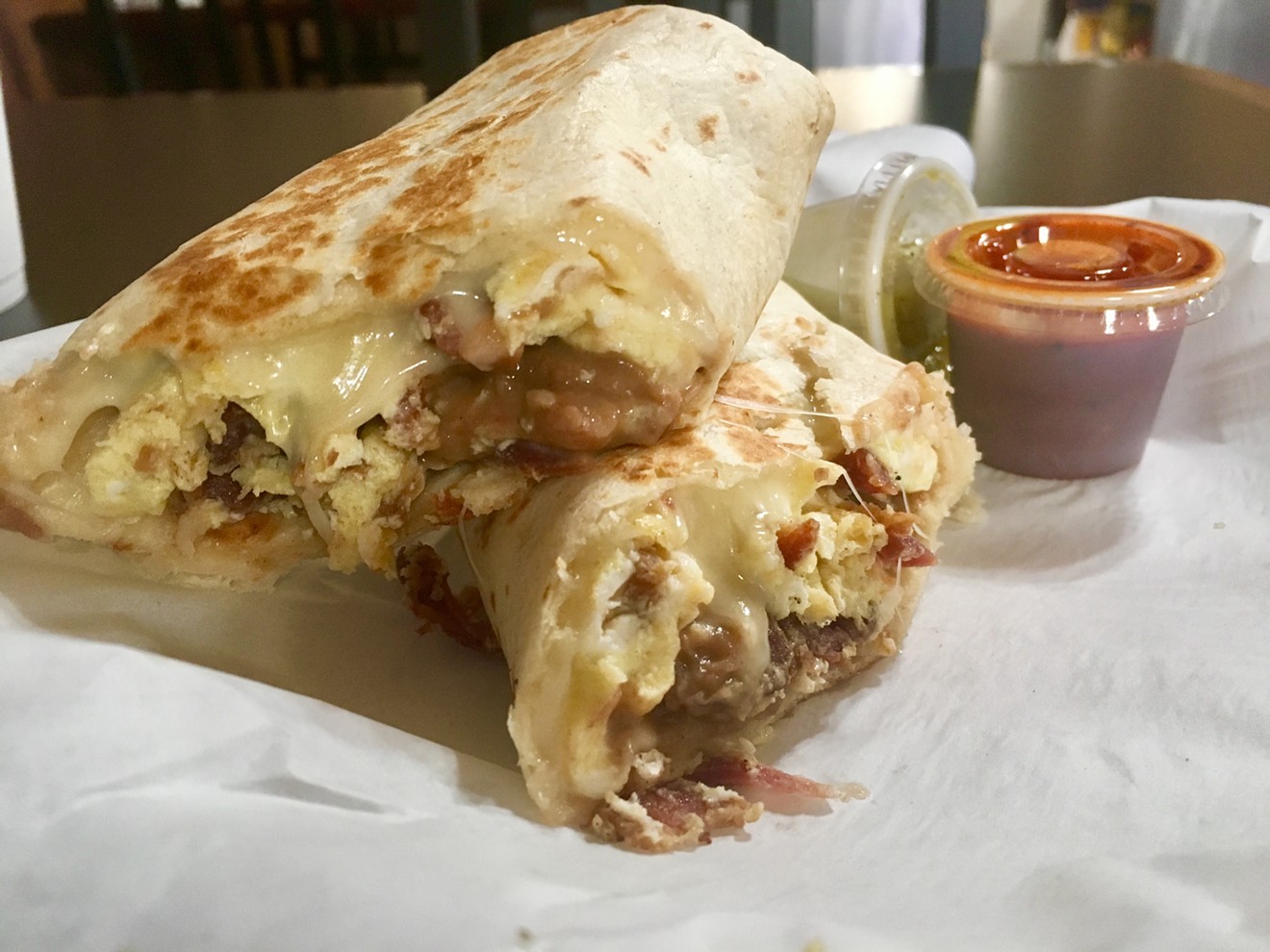 A bacon, egg and cheese breakfast burrito with beans and salsa at Cookie's.