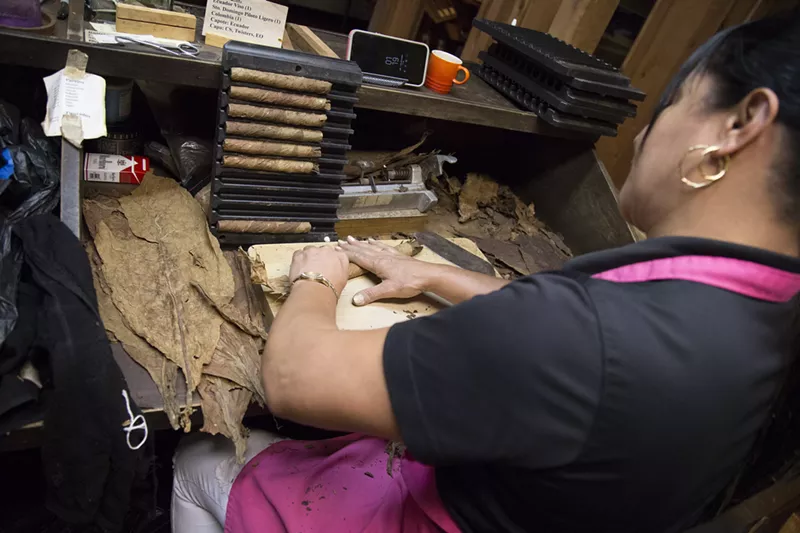 Image: Inaluis Dominguez rolls cigars in-house at House of Cigars Factory. The store sells only custom-made, house-rolled cigars designed by owner Willie Martinez. Martinez says the special blends are what make House of Cigars Factory unique.