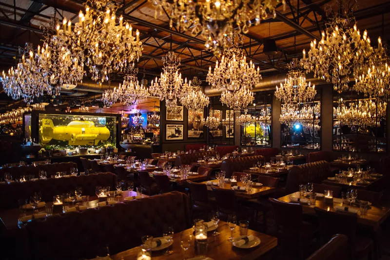 Image: Step inside the windowless restaurant and you'll be greeted by an over-the-top display of 64 chandeliers and an actual submarine submerged in a tank between the bar and the restaurant.