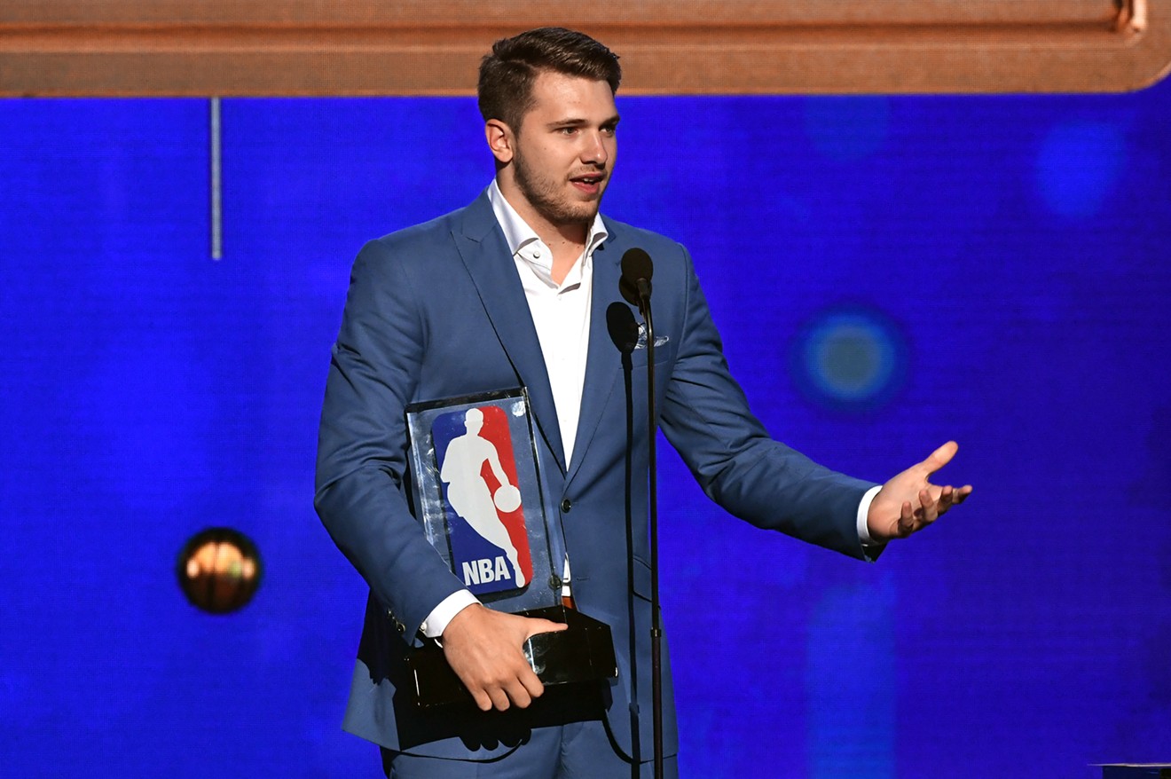 Dallas Mavericks forward Luka Doncic picks up his NBA Rookie of the Year Award on Monday night.