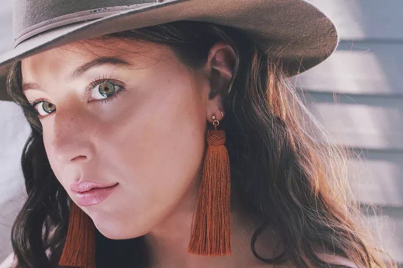 Image: Bare & Golden founder Mary-Brennan Reich modeling her tassel earrings.