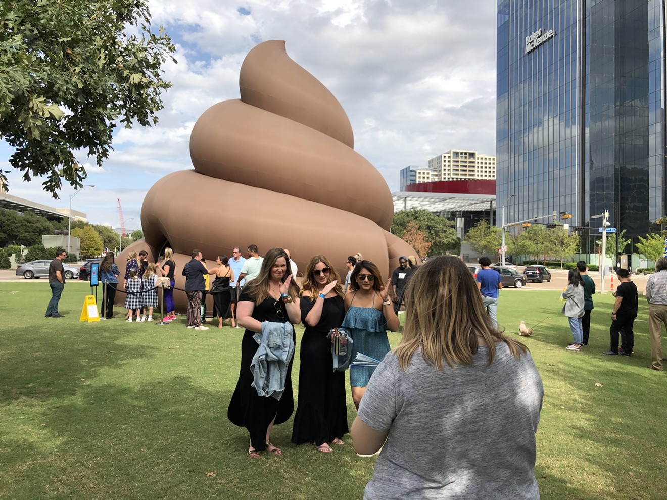 Kelly Gardner, Lisa Manz and Minal Patel pose for a photo in front of a giant, billowy turd that popped up on the northeastern part of Klyde Warren Park on Thursday.