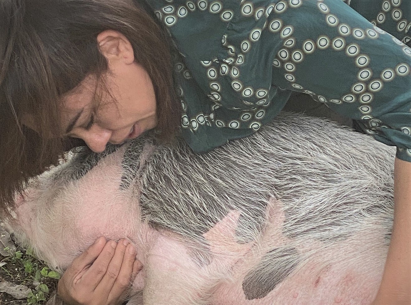 Berenice Deane comforts a recovering Wilbur the Pig.