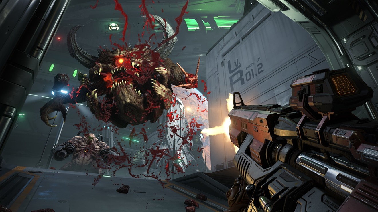 The Doom Slayer blows some very large holes in a Pain Elemental with his high-caliber sniper rifle in DOOM Eternal, one of the many games fans got a glimpse of last weekend at the annual video game convention QuakeCon.
