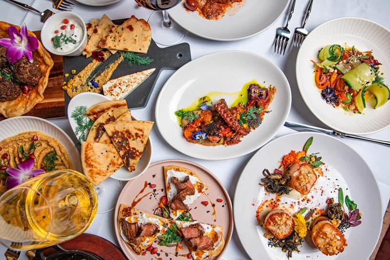 A spread of dishes at Nikki Greek includes plenty of cheese, seafood and wine.
