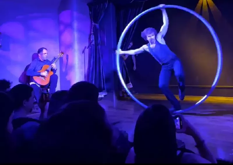 Image: Guitarist Tim Courtney improvises a soundtrack to the movements of David Poznanter as he spins around on a metal ring.