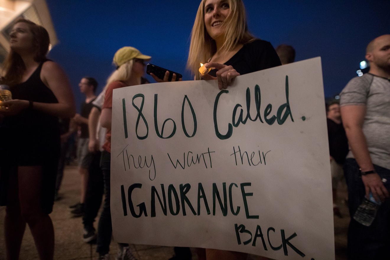 A woman protested Dallas' Confederate monuments Saturday night.