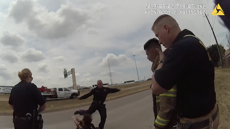 Image: Former Dallas Fire-Rescue paramedic Brad Cox kicks Kyle Vess while he's on the ground.