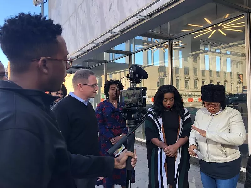 Image: Community organizer Olinka Green speaking to a Dallas Morning News camera next to Keyaira Saunders.