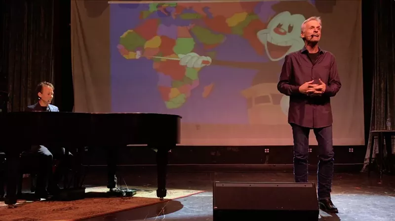 Image: Voice actor and singer Rob Paulsen (right), the voice of Yakko Warner on the animated series Animaniacs, performs a live rendition of "Yakko's World" at the Regent Theater in downtown Los Angeles.