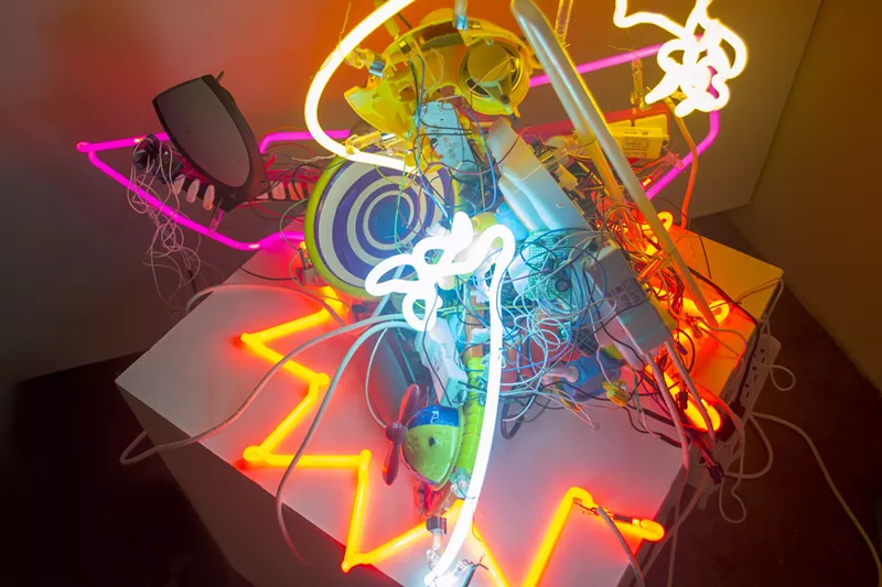 Image: It's art made out of neon tubes and bent toys.