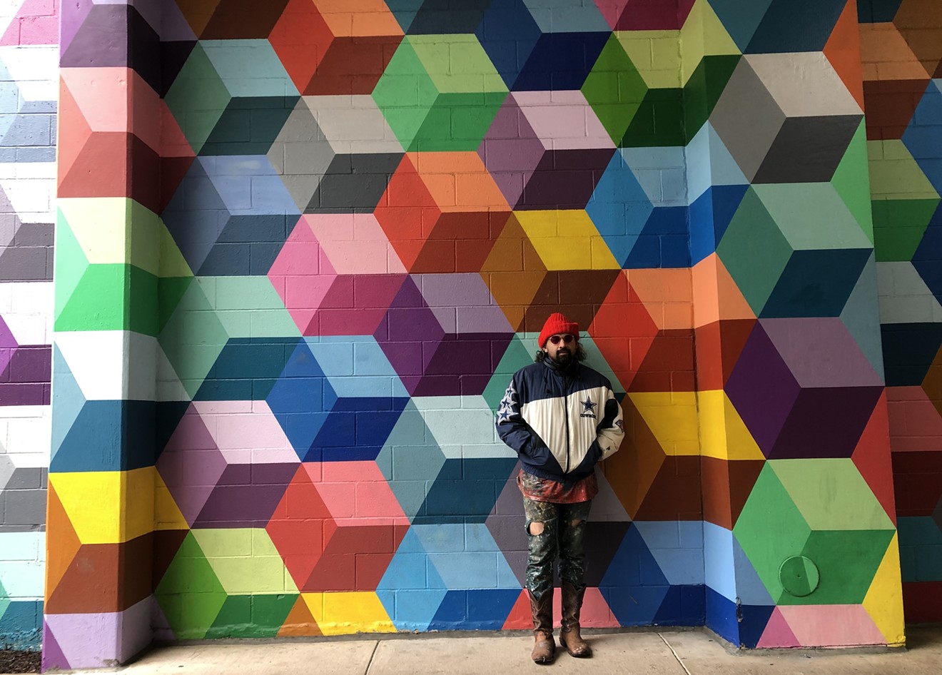 Artist Ricardo Paniagua standing in front of his mural, which he says is being copied.