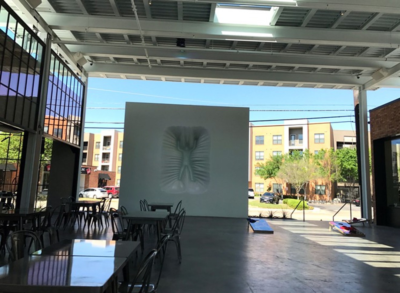 If you've ever wanted to play cornhole at the foot of an 18-foot-tall art installation, the courtyard between Wheelhouse and Sassetta is your kind of hang spot.