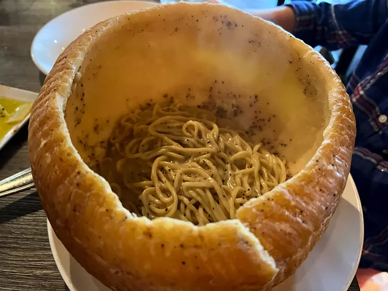 Image: Pasta with cacio e pepe comes in a hollowed-out wheel of Parmesan at Numero 28. Order one and watch neighboring tables follow suit.