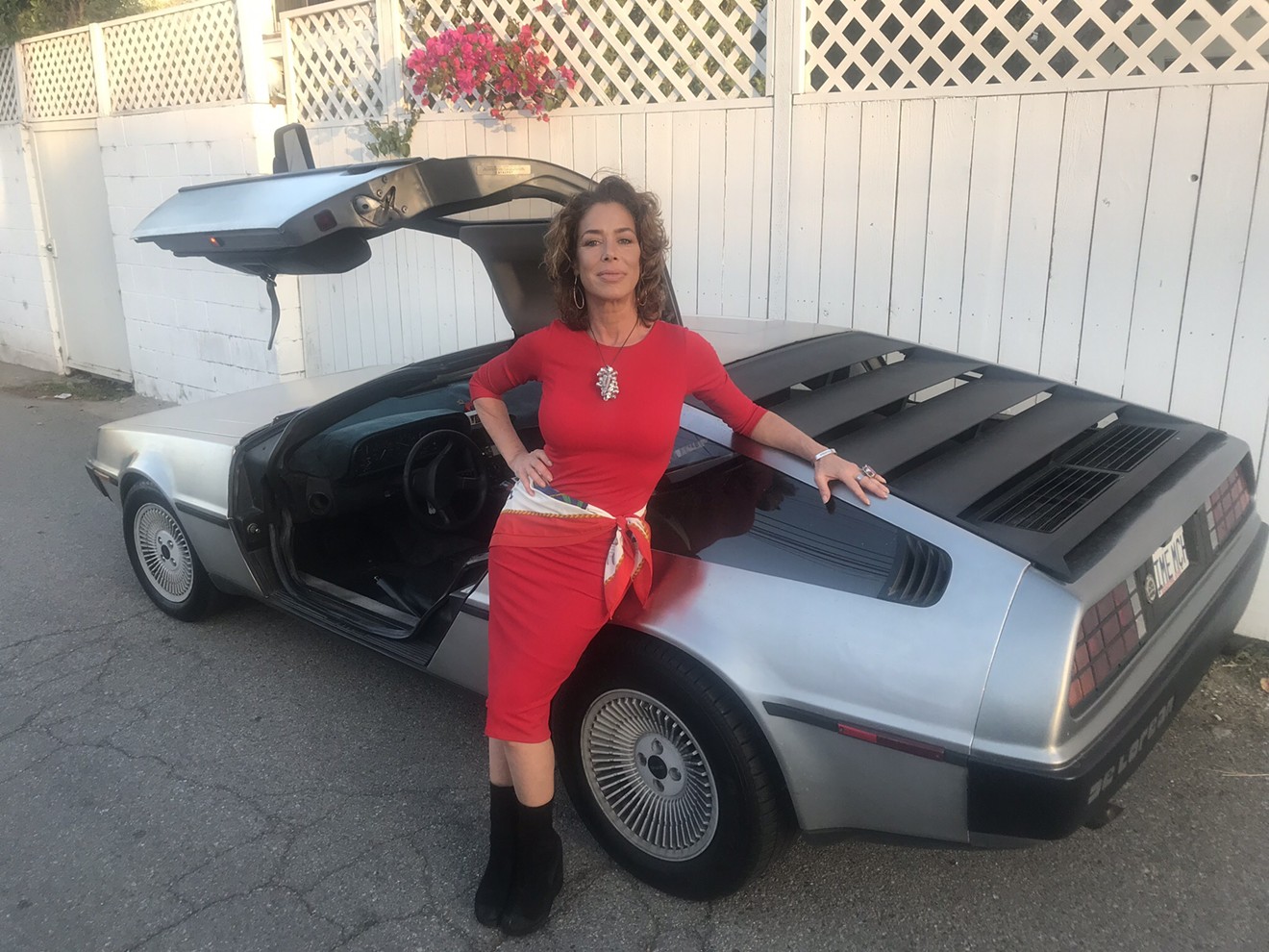 Actress Claudia Wells with the iconic Delorean sports car, the stainless steel behemoth that Doc Brown turns into a time machine in the 1985 comedy Back to the Future in which Wells played Marty McFly's girlfriend Jennifer Parker.