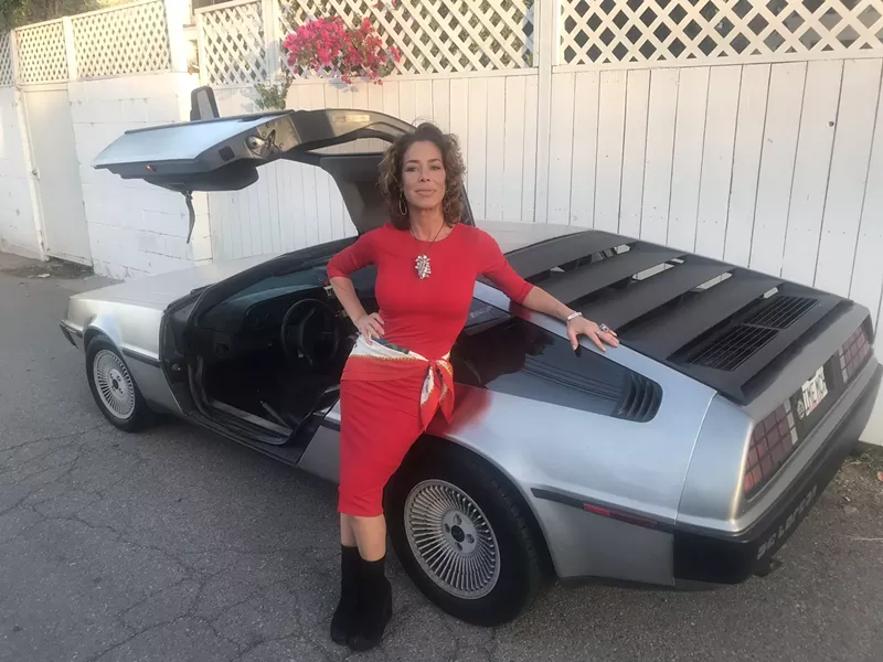 Image: Actress Claudia Wells with the iconic Delorean sports car, the stainless steel behemoth that Doc Brown turns into a time machine in the 1985 comedy Back to the Future in which Wells played Marty McFly's girlfriend Jennifer Parker.