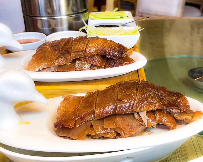 Image: Bamboo House's Peking duck is served with slivered vegetables, Chinese pancakes and tangy plum sauce.