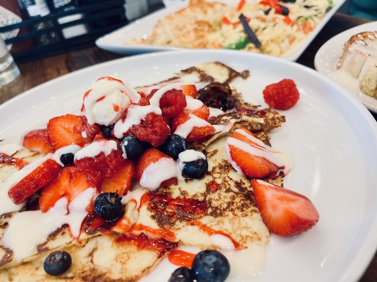 B&B crepes are topped with berries and mascarpone, cream cheese and a raspberry glaze.