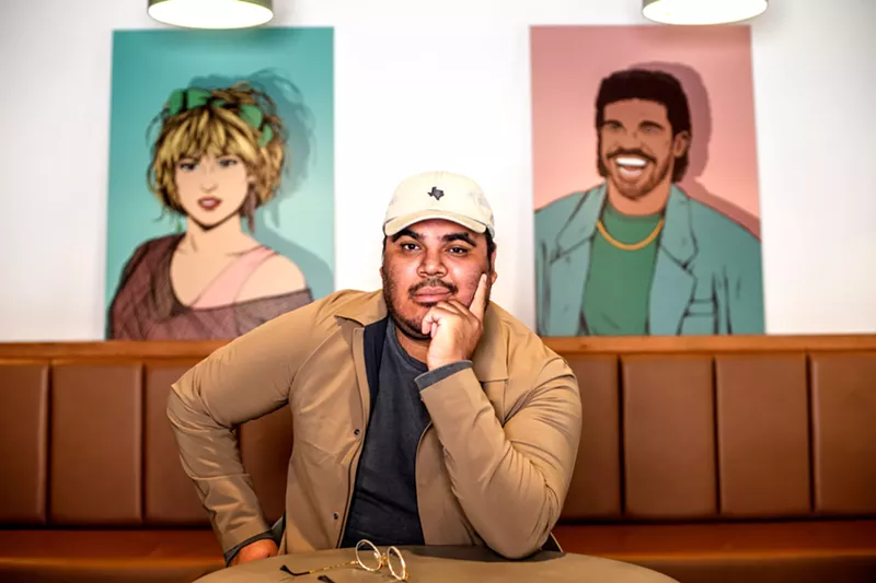 Image: Arturo Torres hangs out with a couple of his illustrations at co-working space Common Desk in Addison.