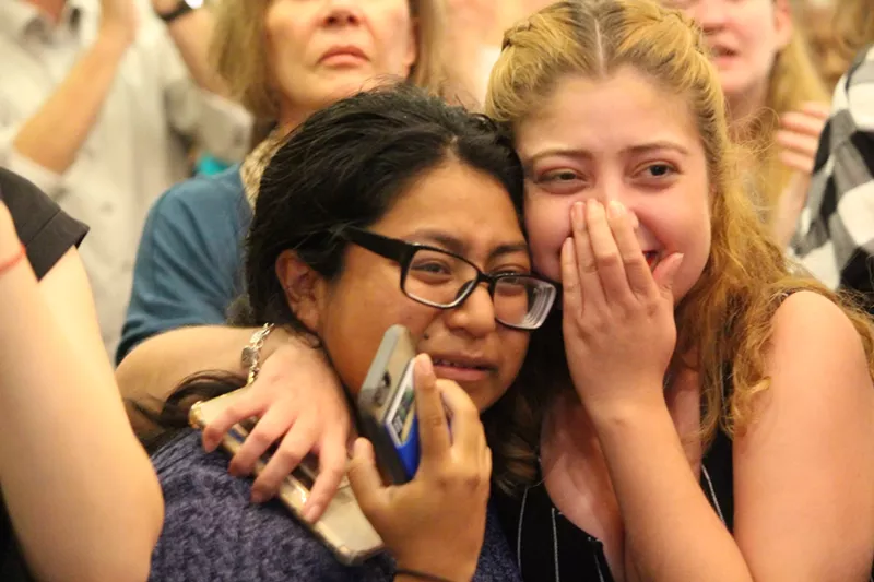 Image: Voters at Colin Allred's election party react to election news.
