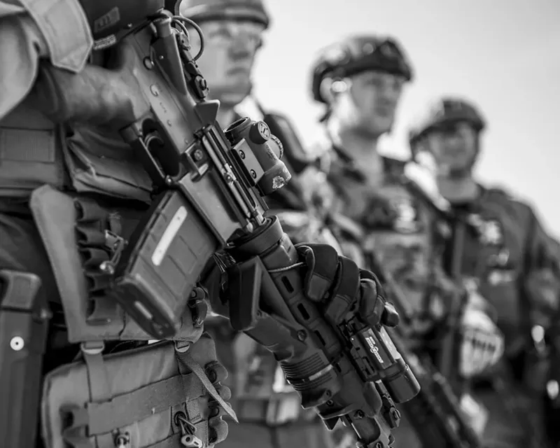 Image: SWAT members are briefed on an impending scenario.