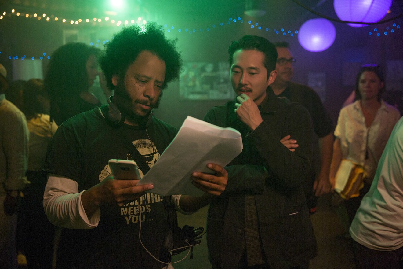 Sorry to Bother You director Boots Riley (left) confers with actor Steven Yeun on the set.