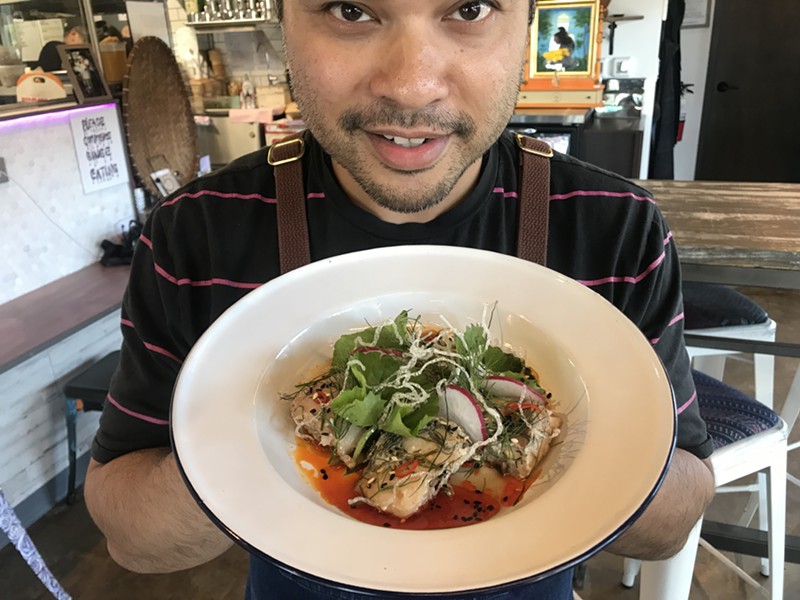 Donny Sirisavath, executive chef at Khao Noodle Shop, displays his mok pa, a fish dish.