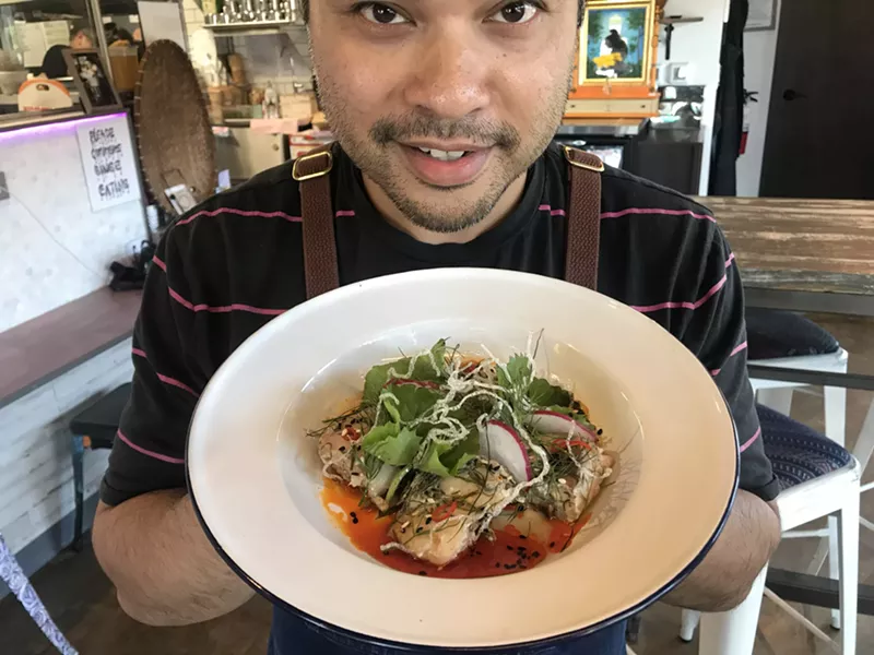 Image: Donny Sirisavath, executive chef at Khao Noodle Shop, displays his mok pa, a fish dish.