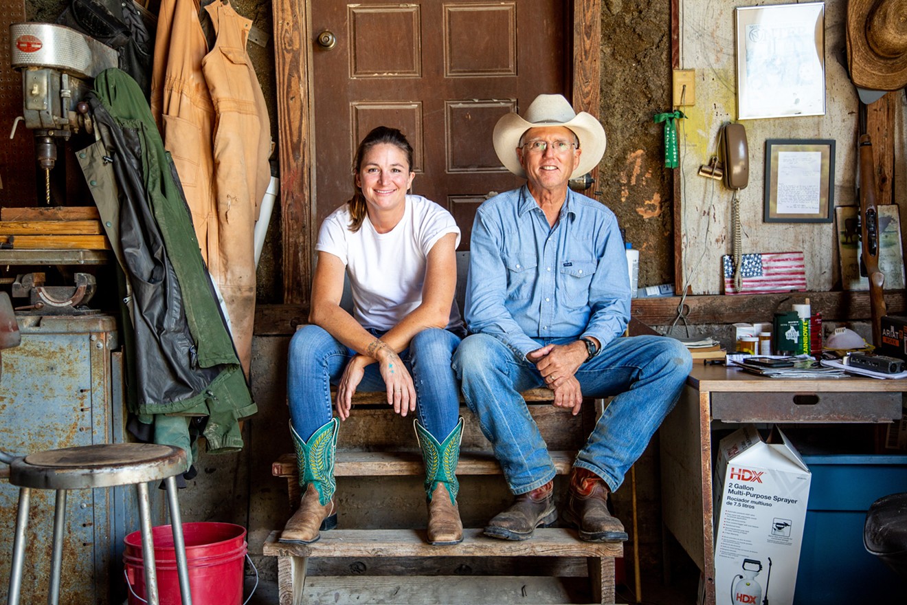 Meredith Ellis and her father, G.C. Ellis, in the barn on their ranch.