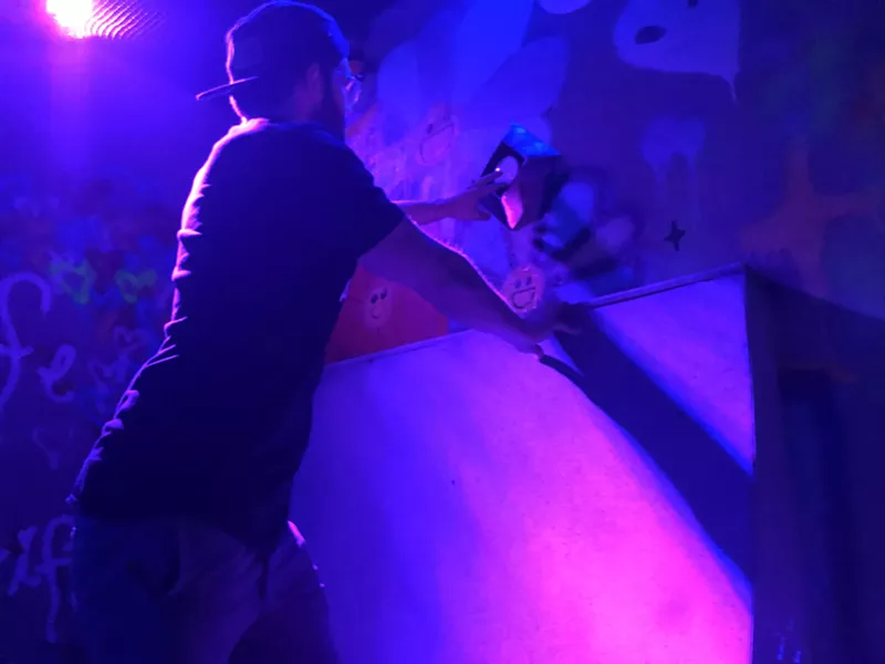 Image: Lewisville Labyrinth owner Raleigh Williams tests one of the interactive sensors in the Ninja Room, one of 42 challenges in his new immersive entertainment experience.