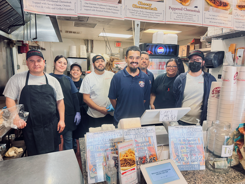 Image: Erick, in the center with the blue shirt, along with his dad, just behind him on his left, along with the crew.
