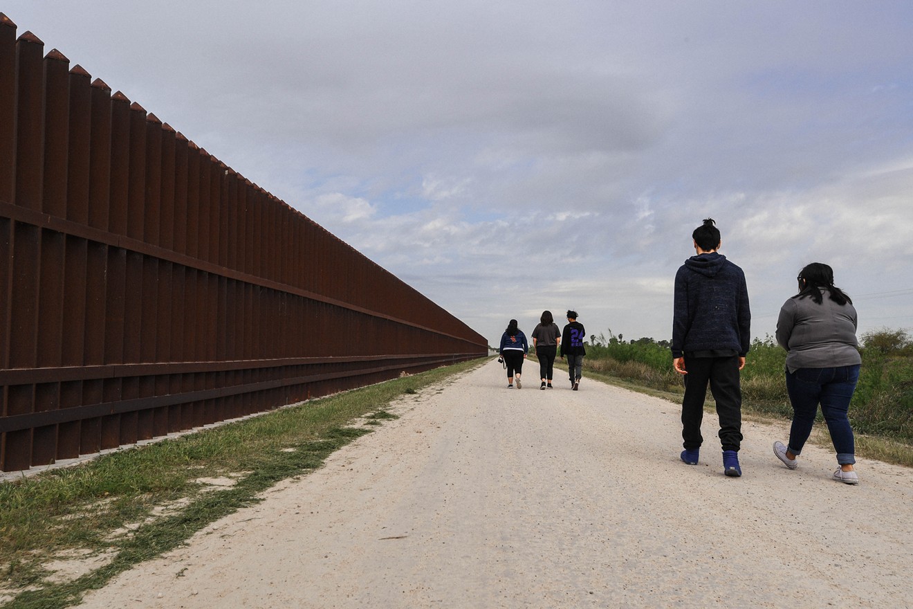 Dallas high school and middle schoolers walk along the border fence in South Texas.