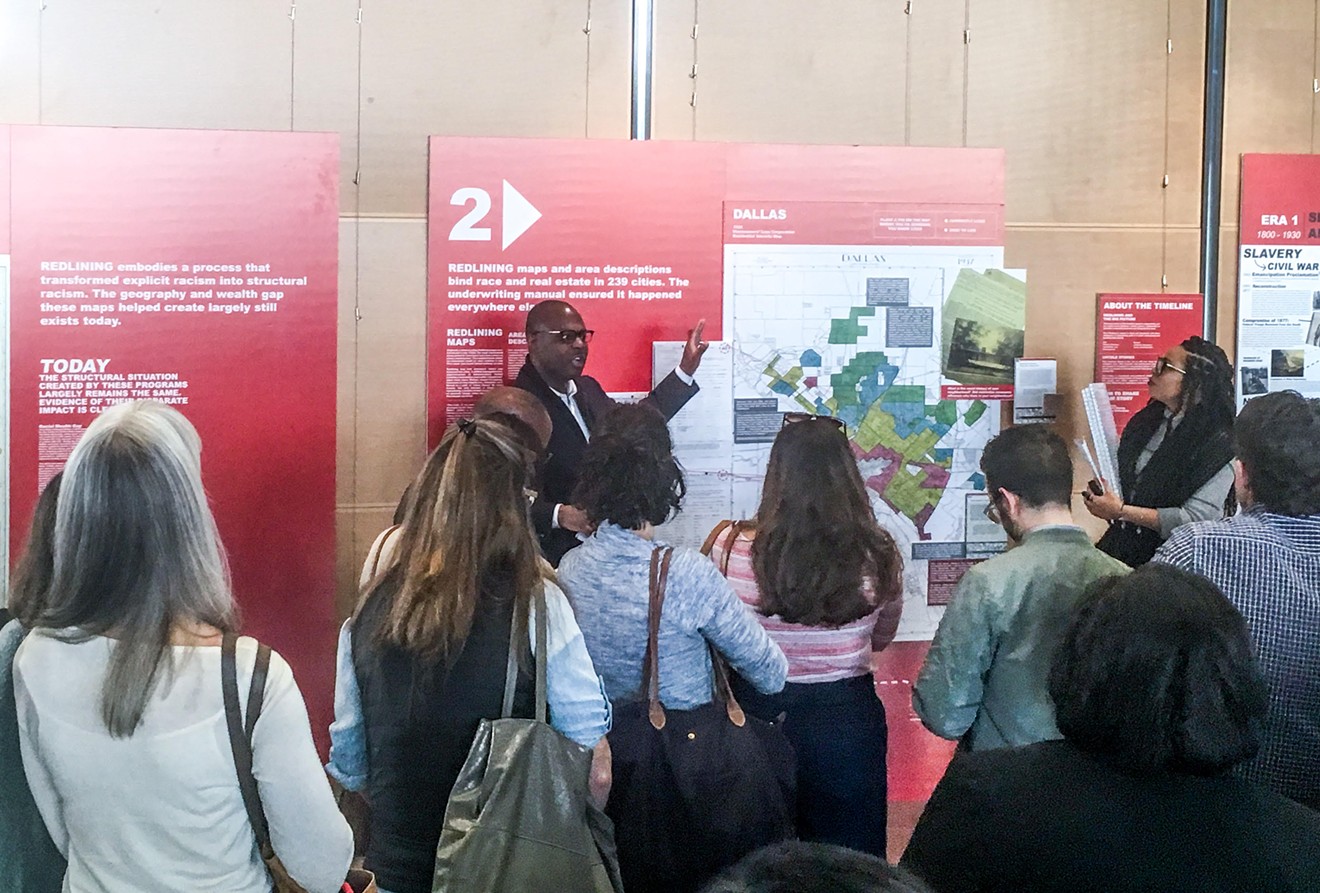 Victor Obaseki, Dallas' first equity officer, gives a tour of the Undesign the Redline exhibit.