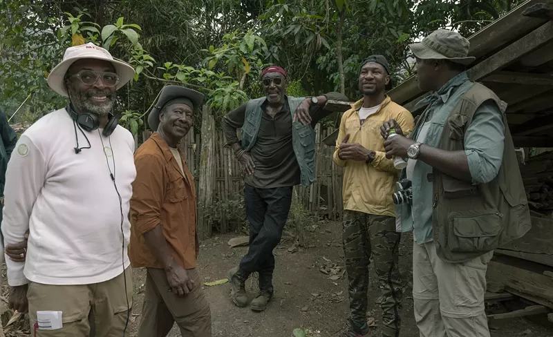 Image: Spike Lee (left) with Delroy Lindo (middle) and Dallas actor Jonathan Majors (fourth from left) filming Da 5 Bloods.