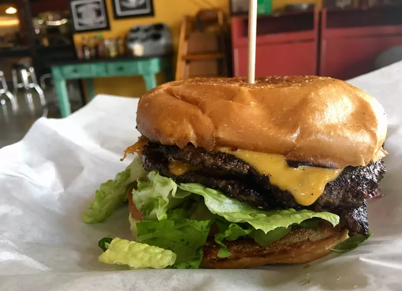 Image: A double cheeseburger at Deep Ellum's Uncle Uber's with lettuce, onion, cheddar and a pickle costs less than 8 bucks.