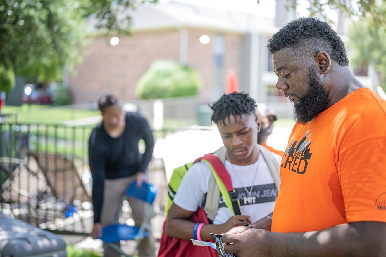 Dallas Cred team member Mar Butler offers job-hunting advice to a young man at Chaucer Place apartments in South Dallas.