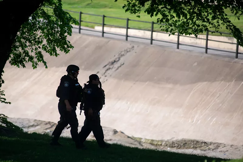 Image: Police searched along White Rock Creek near Central Expressway last month for the person who shot and critically wounded two Dallas police officers and a civilian at a nearby Home Depot.