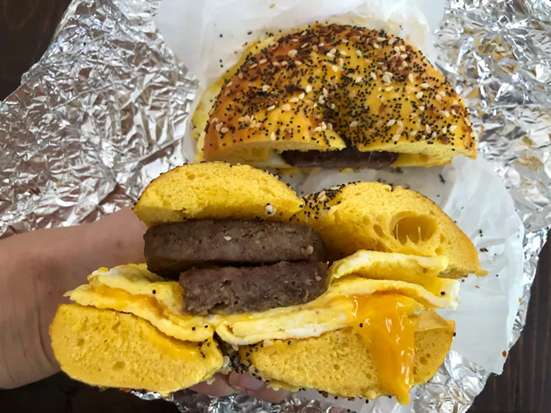 Image: A sandwich with sausage, egg and cheddar on an everything bagel