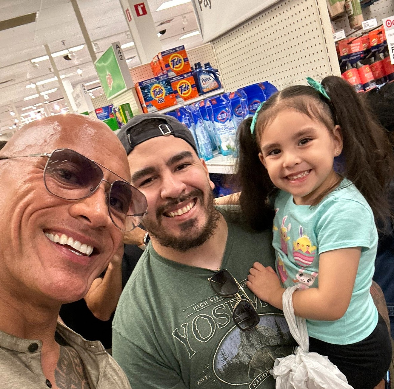 The Rock (left) took a selfie with Ruben Rodriguez (middle) and his daughter before they made friends on X.