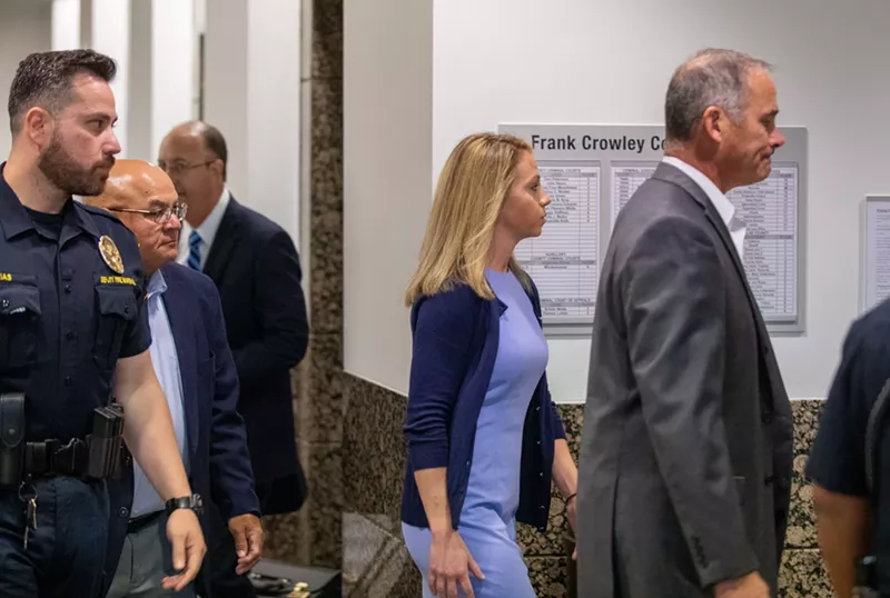 Image: Former Dallas police officer Amber Guyger walks with her attorneys into the Frank Crowley Courts Building. Guyger faces a murder charge in connection with the killing of her upstairs neighbor, Botham Jean.