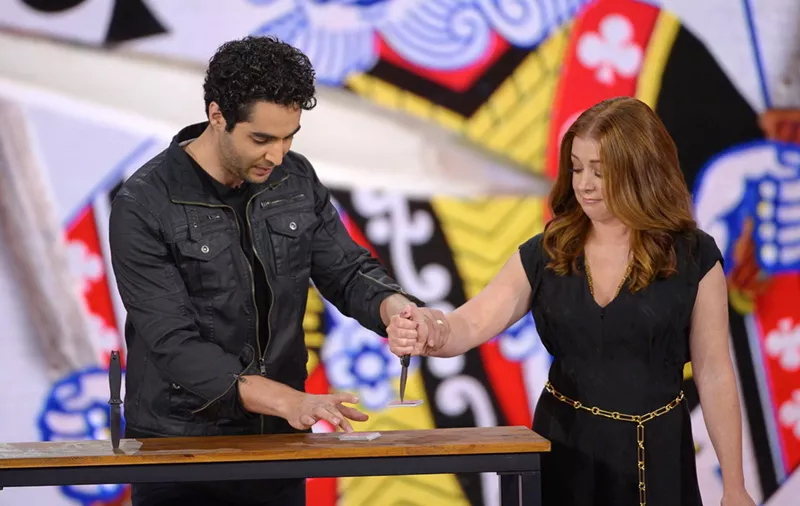Image: Dallas magician Zak Mirz performs a card trick with a cautious Allison Hannigan in Las Vegas on the set of The CW show Penn & Teller: Fool Us that airs on Friday.