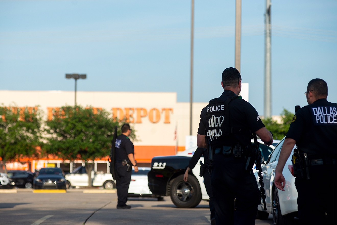 Dallas Police officers gathered outside the Home Depot near Forest Lane and U.S. Route 75 on Tuesday.
