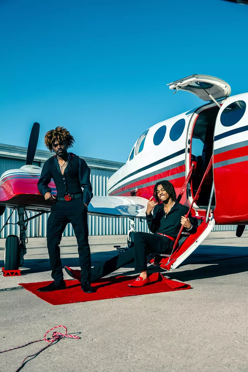 Image: Two men next to a plane