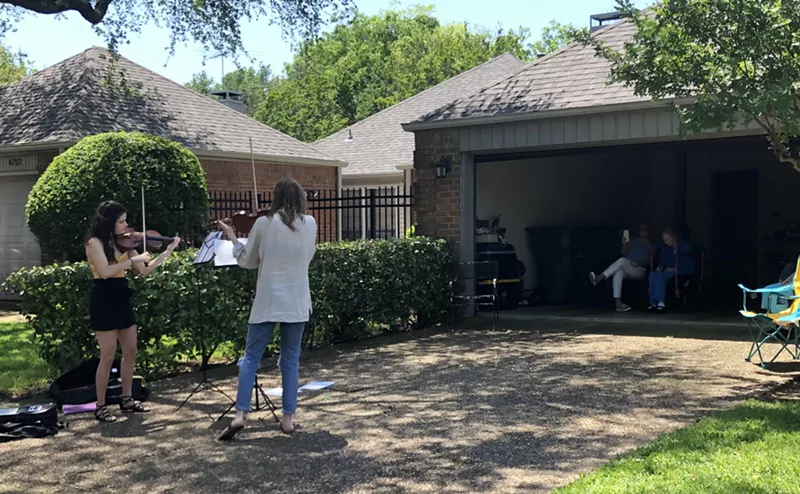Image: Two violinists came out to serenade 100-year-old MaryBelle Judd.