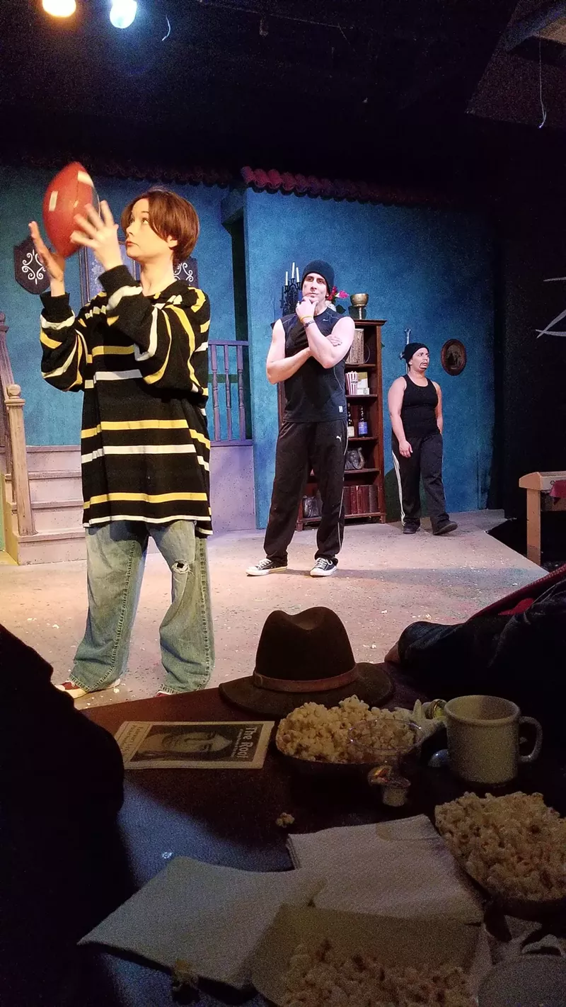 Image: Dan Janjigian (middle) reprises his famous role from Tommy Wiseau's The Room as the tough drug dealer Chris R. in the middle of a scene at Pocket Sandwich Theatre's parody The Roof between Rhonda Durant (left) and Janjigian's Roof counterpart "Kurt R," played by Melissa Torres (right).